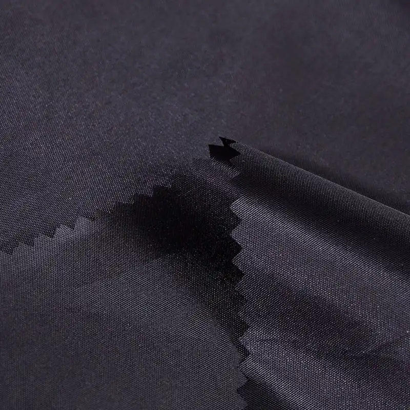 How does PVC coating enhance the waterproof properties of polyester taffeta? What is the waterproof rating of this fabric and can it cope with extreme weather conditions?